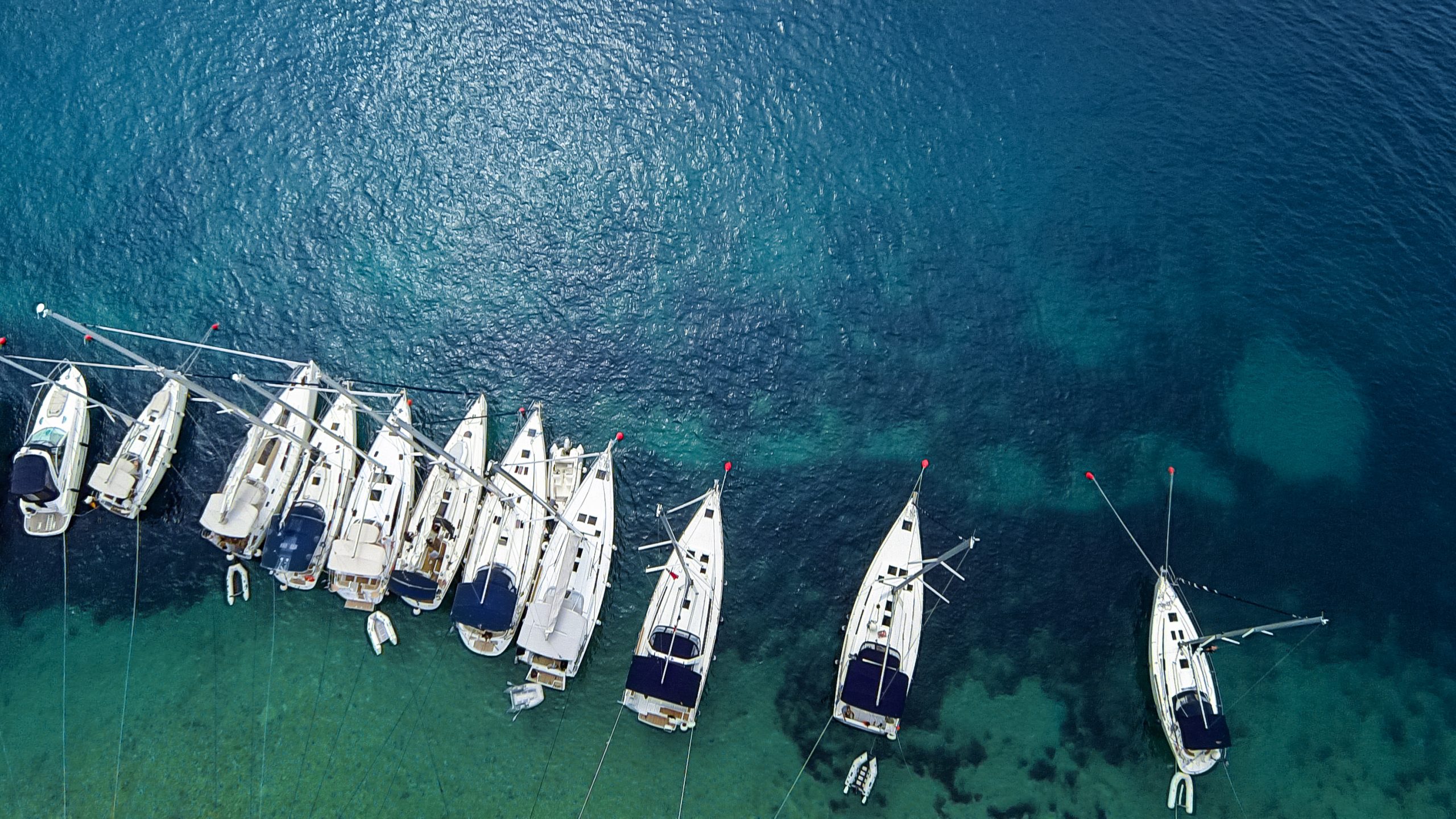Aerial view on marina bay with sailboats and yachts.